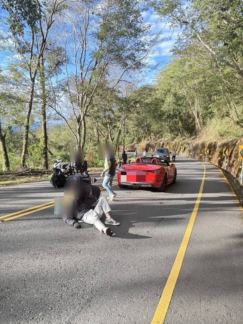 机车骑士摔落,其他机车骑士下来查看并协助。(仁爱警方提供) 机车骑士摔落,其他机车骑士下来查看并协助。(仁爱警方提供)