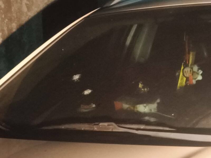 紧临国中外的巷道内成排自小客车，挡风玻璃上出现弹痕。（民众提供）