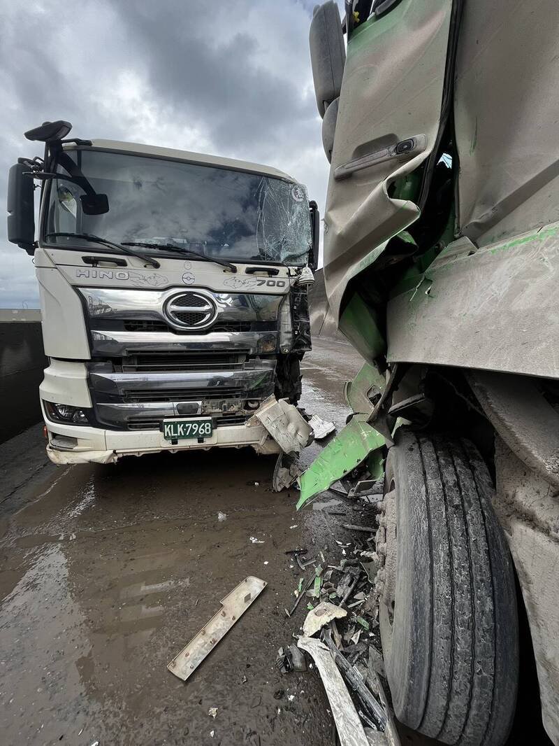 台北港砂石土方车道今天午后发生2辆砂石车对撞事故，其中一辆砂石车驾驶一度受困驾驶座内，经港务消防队员以破坏剪破坏车体后，才将驾驶救出送医救治。（记者林嘉东翻摄）
